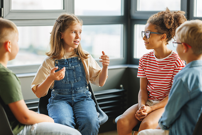 Kids sitting in a room talking