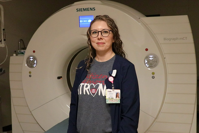 Radiologic technologist standing in front of radiology equipment