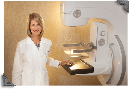 Female doctor next to digital mammography machine