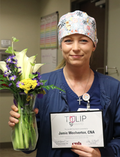 Jamie Woolverton, CNA, with TULIP award and flowers