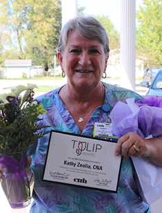 Kathy Zeolia, CNA with TULIP Award and flowers