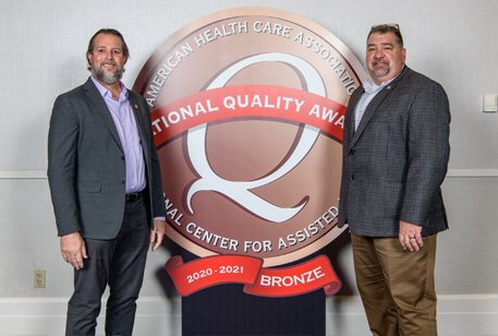 Long Term Care administrators with quality award banner