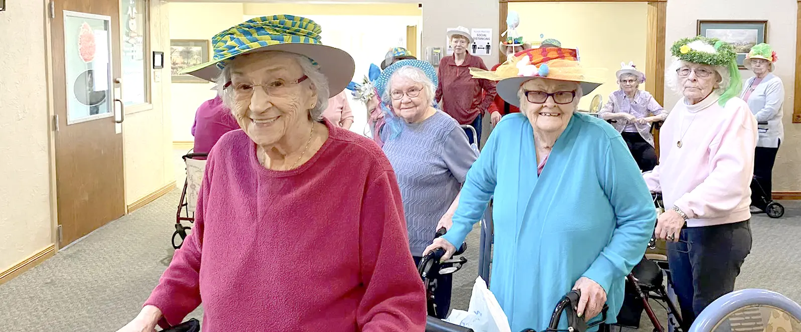 Women smiling and wearing hats